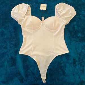 “revamped” white bodysuit with puffy sleeves